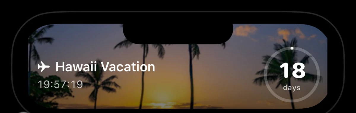 iPhone Dynamic Island expanded to show DayDrop's countdown: Hawaii Vacation, 18 days, a live hours-minutes-seconds timer and a progress ring over a beach-at-dusk background